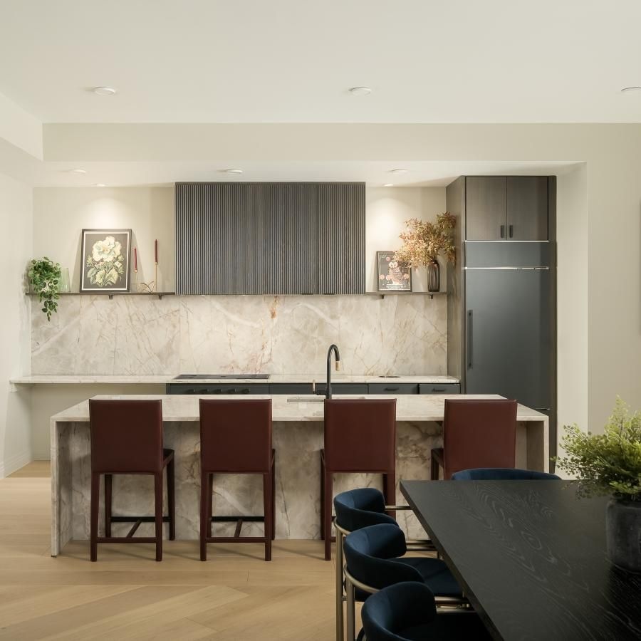 a kitchen with a bar and chairs